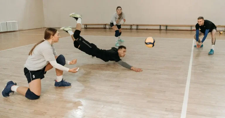 Best Volleyball Knee Pads: Man dives for a volleyball while wearing Knee Pads for Volleyball